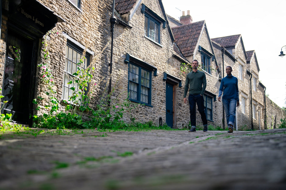 Two people walking down a cobbled street