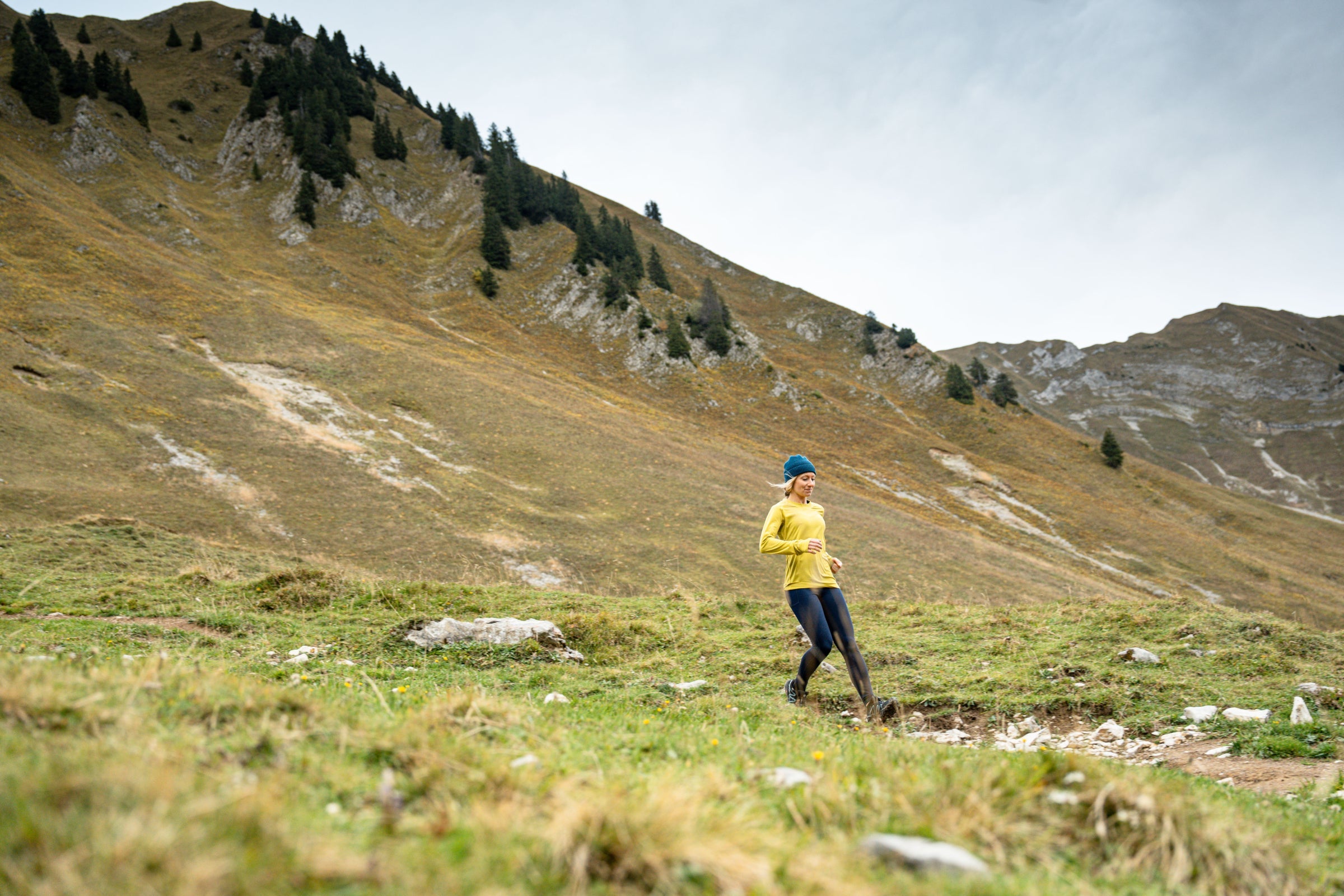 Woman running on a mountain trail