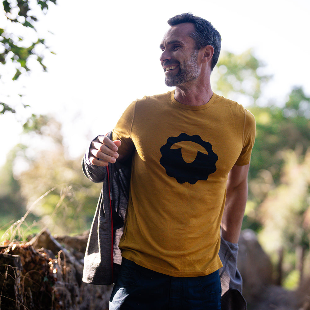 Isobaa | Mens Merino 150 Emblem Tee (Mustard/Navy) | Conquer trails and city streets in comfort with Isobaa's superfine Merino T-Shirt. | Model: Ben