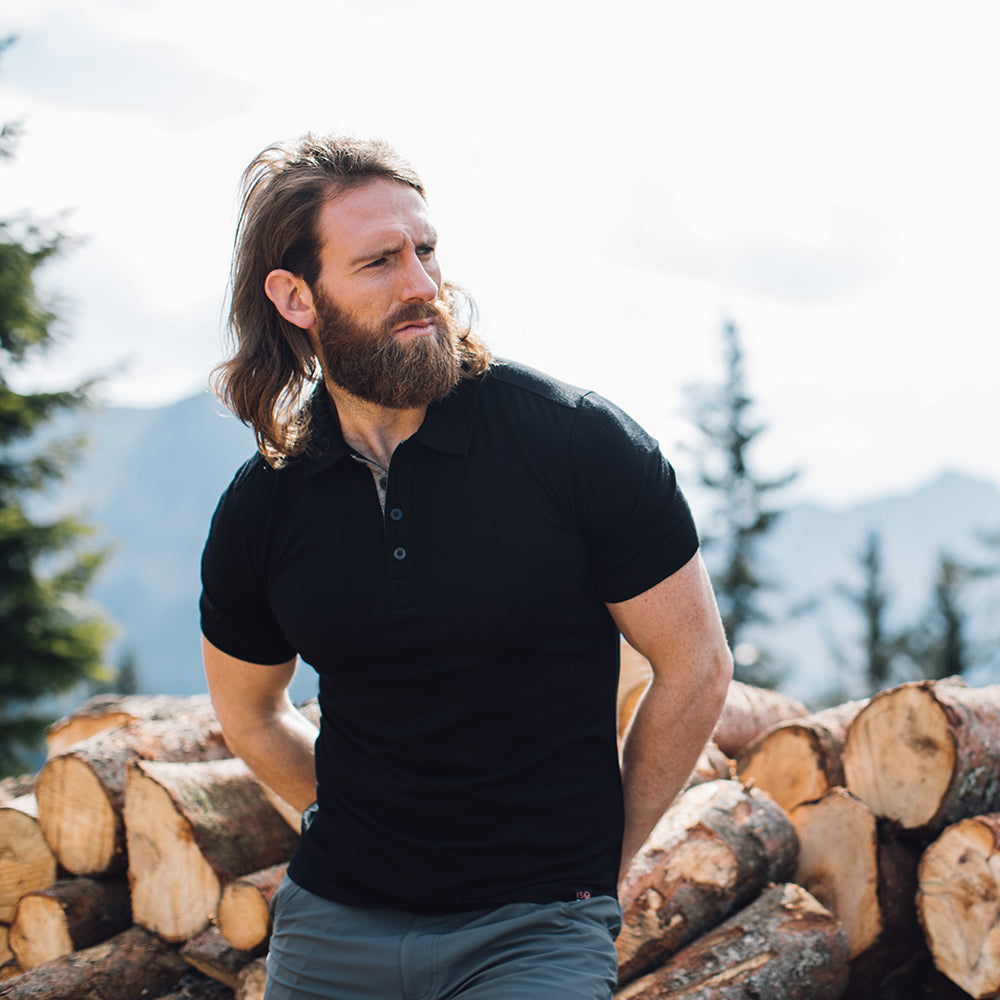 Isobaa | Mens Merino 180 Short Sleeve Polo Shirt (Black) | The ultimate Merino wool polo — perfect for weekend hikes, bike commutes, post-adventure coffee stops, office days, and everything in-between. | Model: Craig