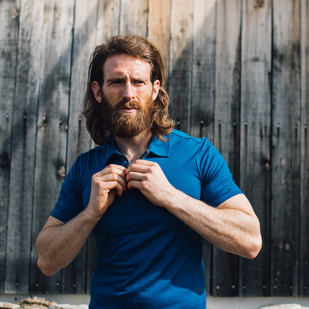 Isobaa | Mens Merino 180 Short Sleeve Polo Shirt (Black) | The ultimate Merino wool polo — perfect for weekend hikes, bike commutes, post-adventure coffee stops, office days, and everything in-between. | Model: Craig