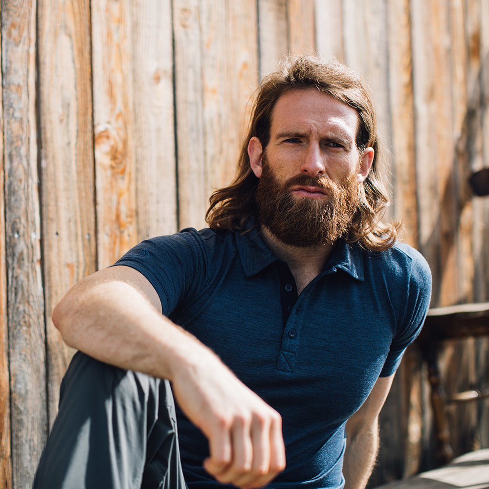 Isobaa | Mens Merino 180 Short Sleeve Polo Shirt (Black) | The ultimate Merino wool polo — perfect for weekend hikes, bike commutes, post-adventure coffee stops, office days, and everything in-between. | Model: Craig