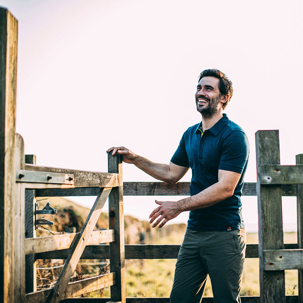 Isobaa | Mens Merino 180 Short Sleeve Polo Shirt (Black) | The ultimate Merino wool polo — perfect for weekend hikes, bike commutes, post-adventure coffee stops, office days, and everything in-between. | Model: Duncan