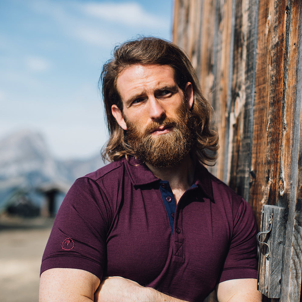 Isobaa | Mens Merino 180 Short Sleeve Polo Shirt (Black) | The ultimate Merino wool polo — perfect for weekend hikes, bike commutes, post-adventure coffee stops, office days, and everything in-between. | Model: Craig