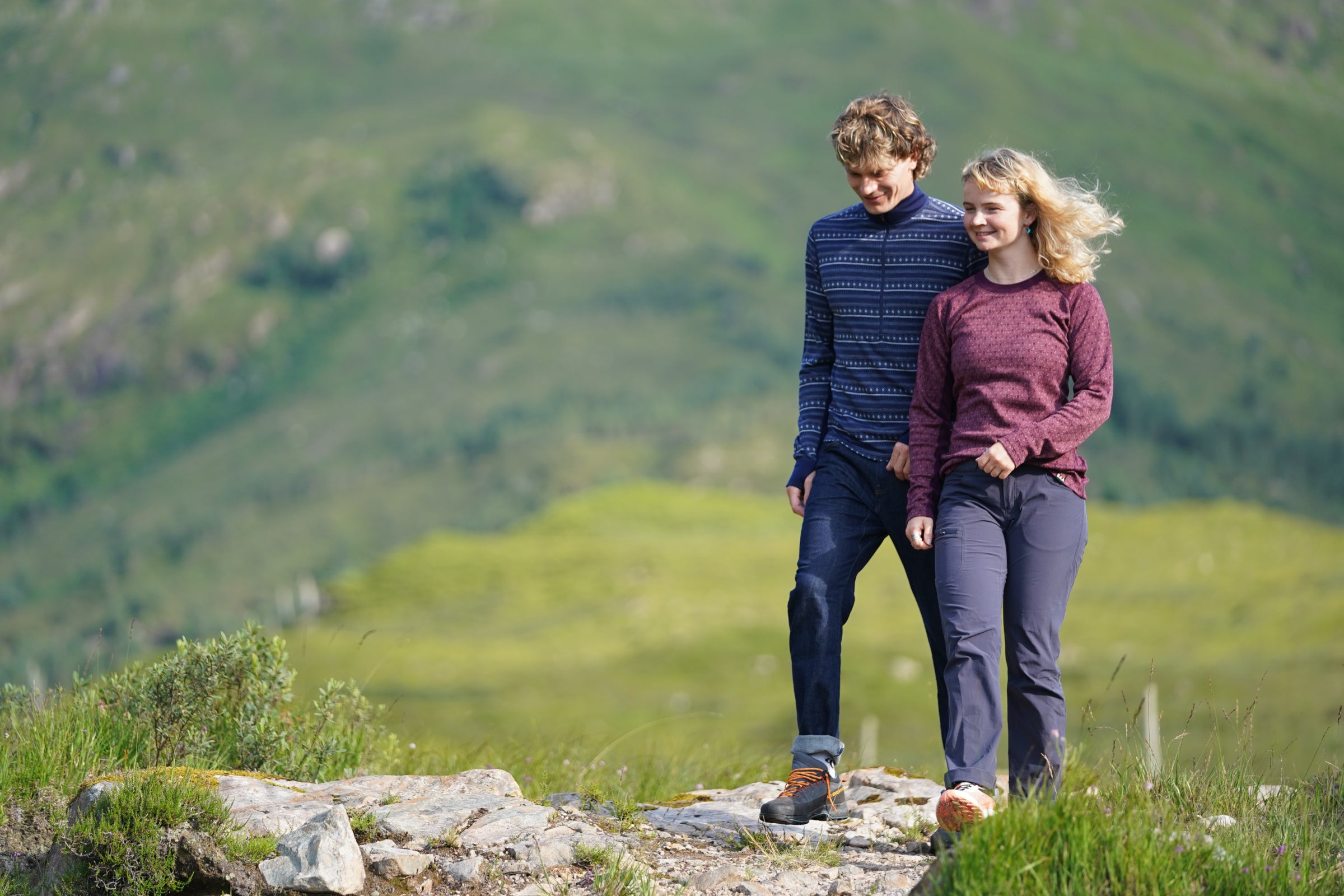 Two people walking outdoors wearing Isobaa jacquard merino tops