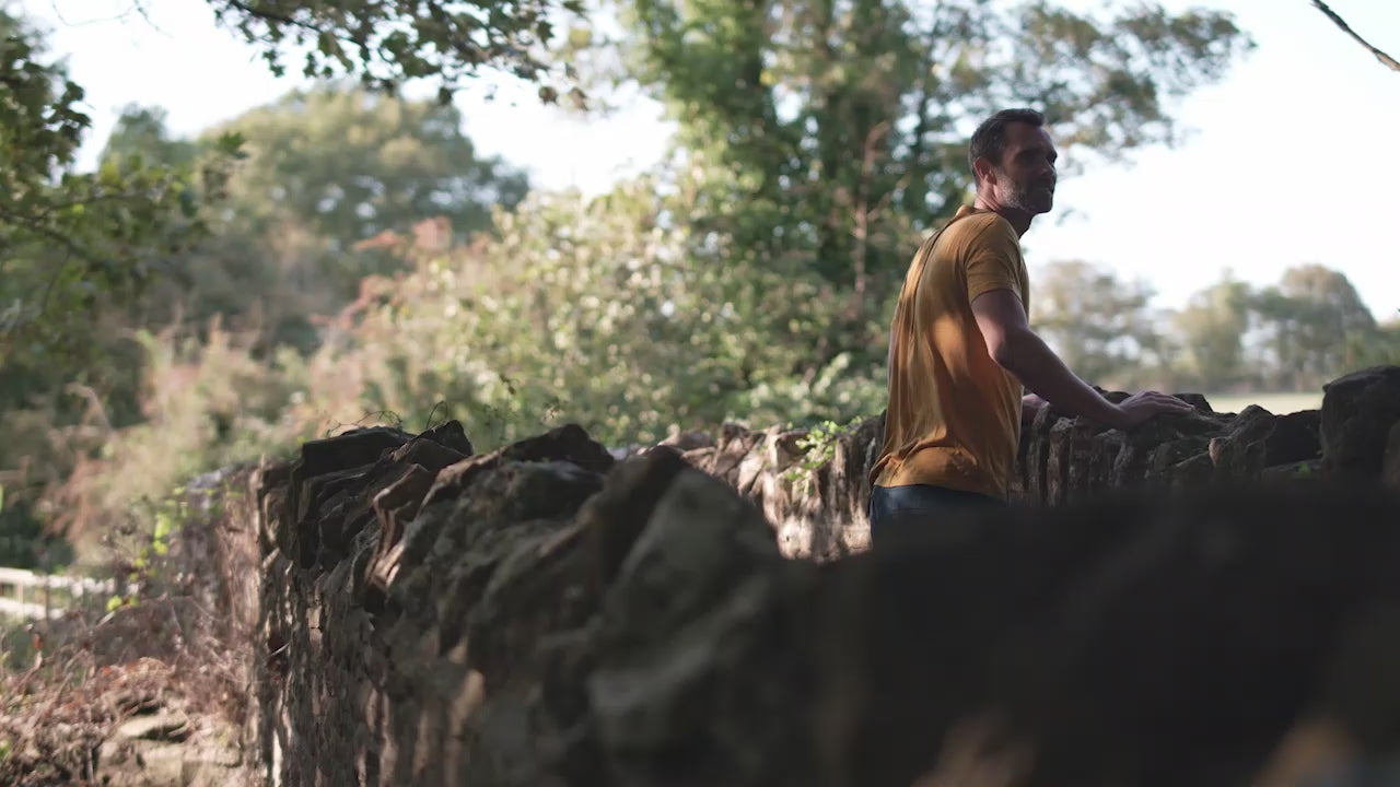 Isobaa | Mens Merino 150 Emblem Tee (Mustard/Navy) | Conquer trails and city streets in comfort with Isobaa's superfine Merino T-Shirt. | class: 90% 50% | Model: Ben