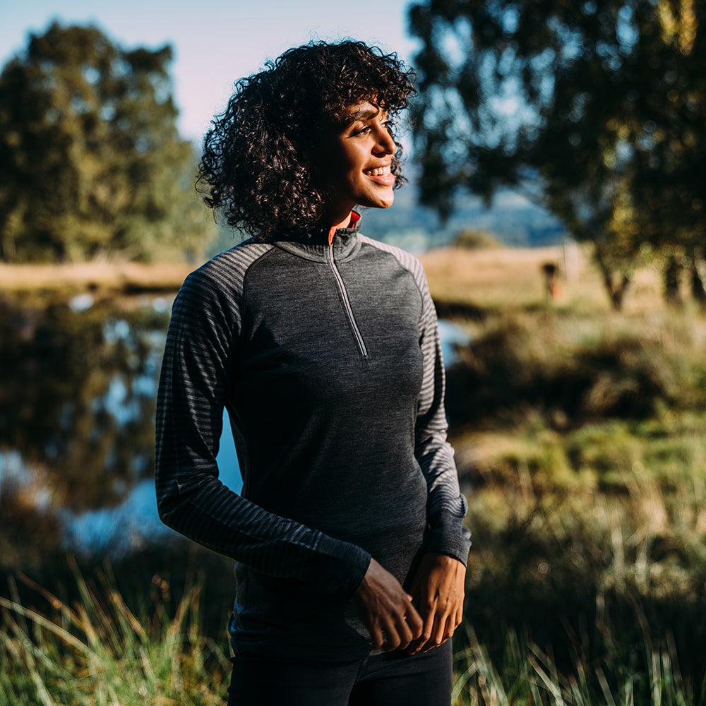 Isobaa | Womens Merino 200 Long Sleeve Zip Neck (Stripe Smoke/Charcoal) | Experience the best of 200gm Merino wool with this ultimate half-zip top – your go-to for challenging hikes, chilly bike commutes, post-workout layering, and unpredictable weather. | Model: Micah