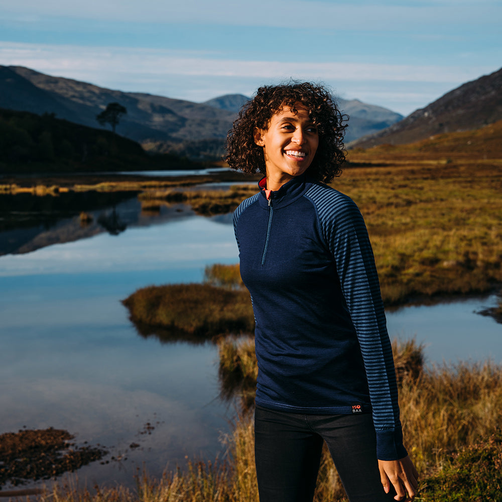 Isobaa | Womens Merino 200 Long Sleeve Zip Neck (Stripe Navy/Denim) | Experience the best of 200gm Merino wool with this ultimate half-zip top – your go-to for challenging hikes, chilly bike commutes, post-workout layering, and unpredictable weather. | Model: Micah