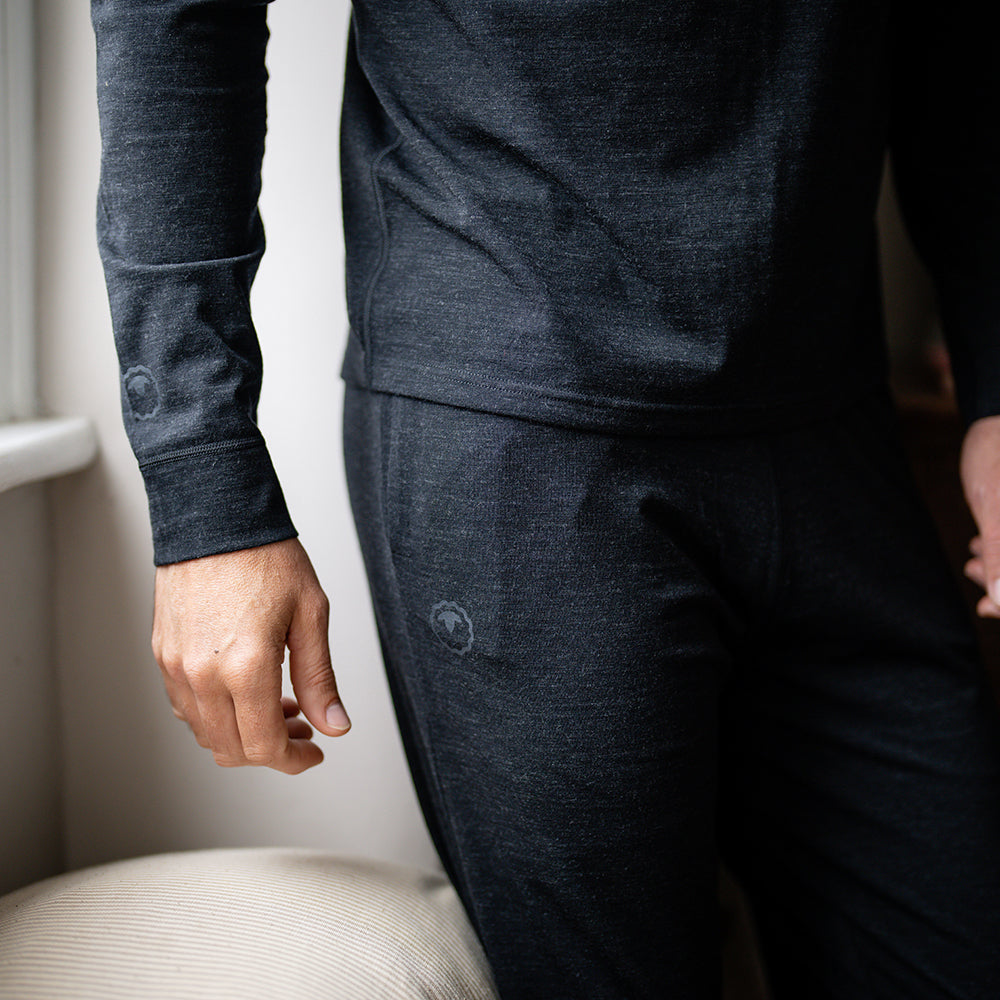 Isobaa | Mens Merino Blend 160 PJ Henley (Black Melange) | Relax with our superfine Merino blend Henley. | Model: Ben