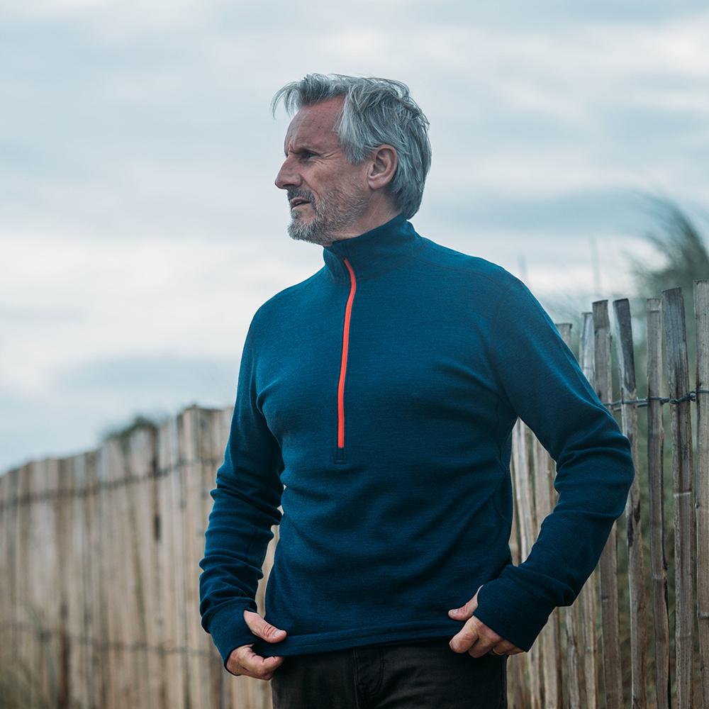 Isobaa | Mens Merino 320 Long Sleeve Half Zip (Petrol/Orange) | Conquer cold trails, blustery commutes, and unpredictable weather with the ultimate Merino wool half-zip top. | Model: Simon