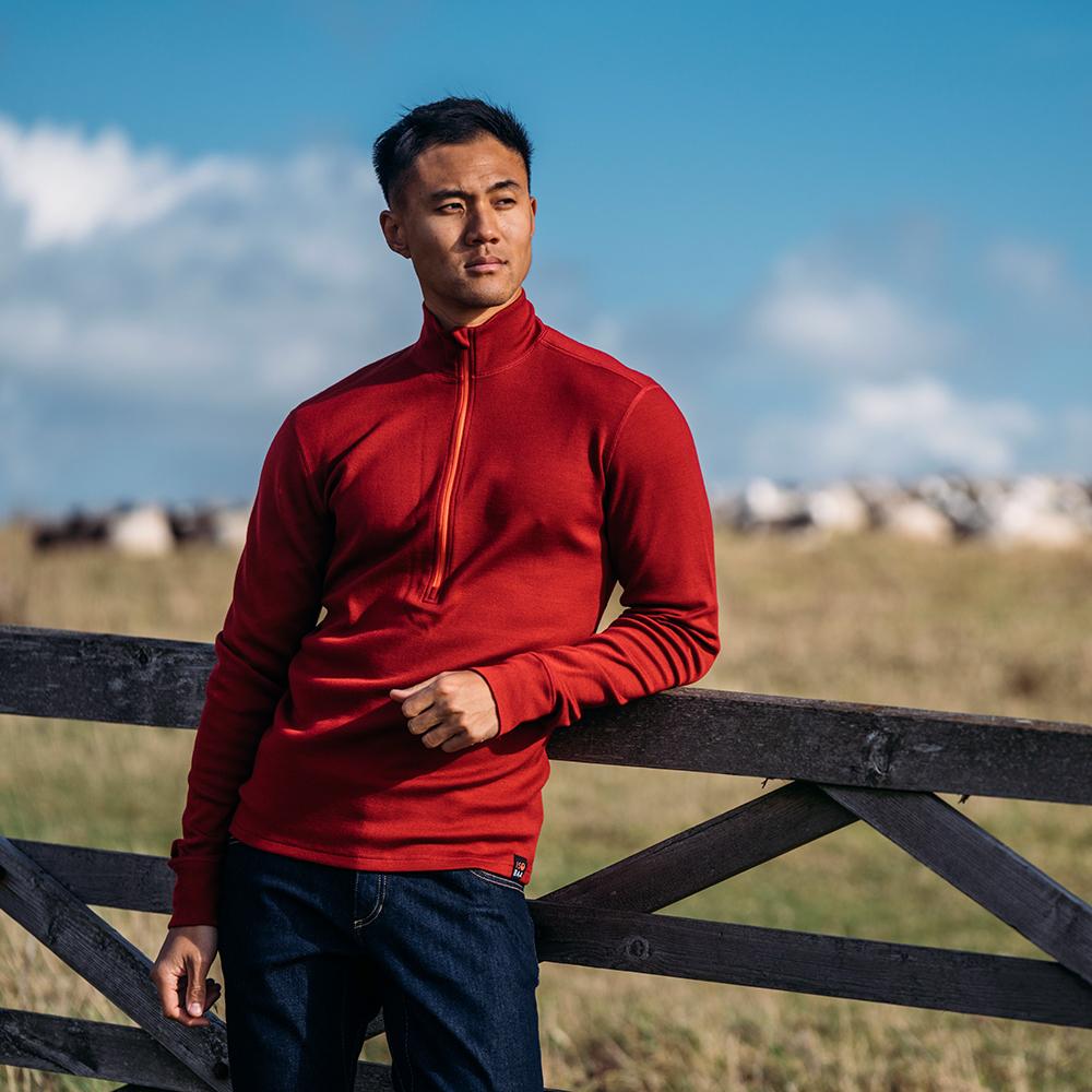 Isobaa | Mens Merino 320 Long Sleeve Half Zip (Red/Orange) | Conquer cold trails, blustery commutes, and unpredictable weather with the ultimate Merino wool half-zip top. | Model: Donald