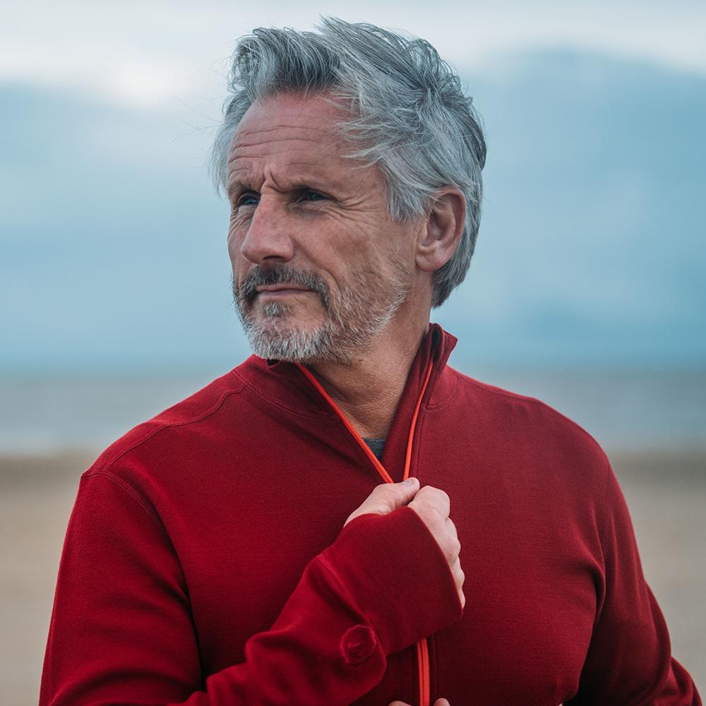 Isobaa | Mens Merino 320 Long Sleeve Half Zip (Red/Orange) | Conquer cold trails, blustery commutes, and unpredictable weather with the ultimate Merino wool half-zip top. | Model: Simon