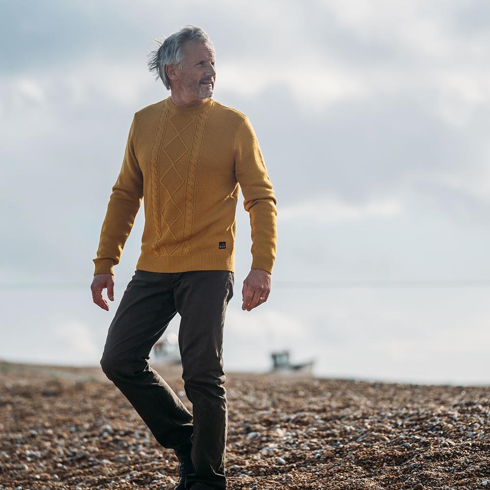 Isobaa | Mens Merino Cable Sweater (Mustard) | Experience timeless style and outdoor-ready performance with our Merino wool crew neck sweater. | Model: Simon