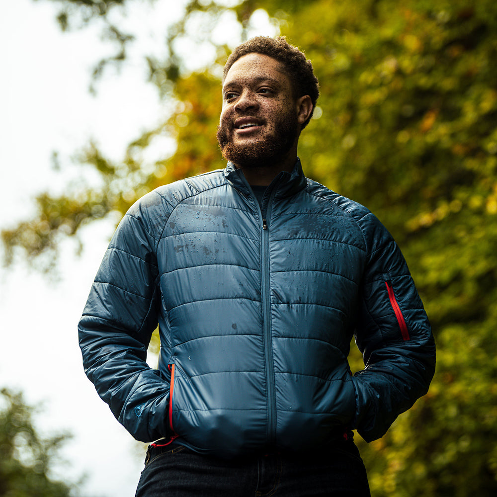 Isobaa | Mens Packable Insulated Jacket (Petrol/Orange) | Exceptional warmth, packable convenience, and sustainable design with our lightweight Merino wool jacket. | Model: Shaquille
