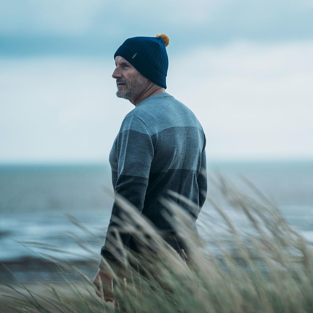 Isobaa | Merino Bobble Beanie (Navy/Mustard) | Stay warm and stylish with Isobaa's extra-fine Merino bobble beanie! Its cosy warmth, playful bobble, and classic rib-knit design will make it your go-to winter essential for hikes, city strolls, and everything in between.