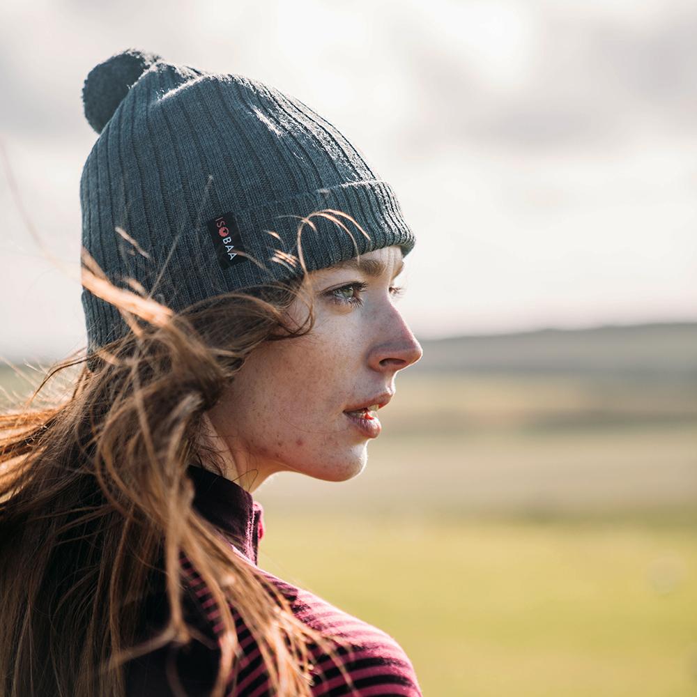 Isobaa | Merino Bobble Beanie (Smoke) | Stay warm and stylish with Isobaa's extra-fine Merino bobble beanie! Its cosy warmth, playful bobble, and classic rib-knit design will make it your go-to winter essential for hikes, city strolls, and everything in between.