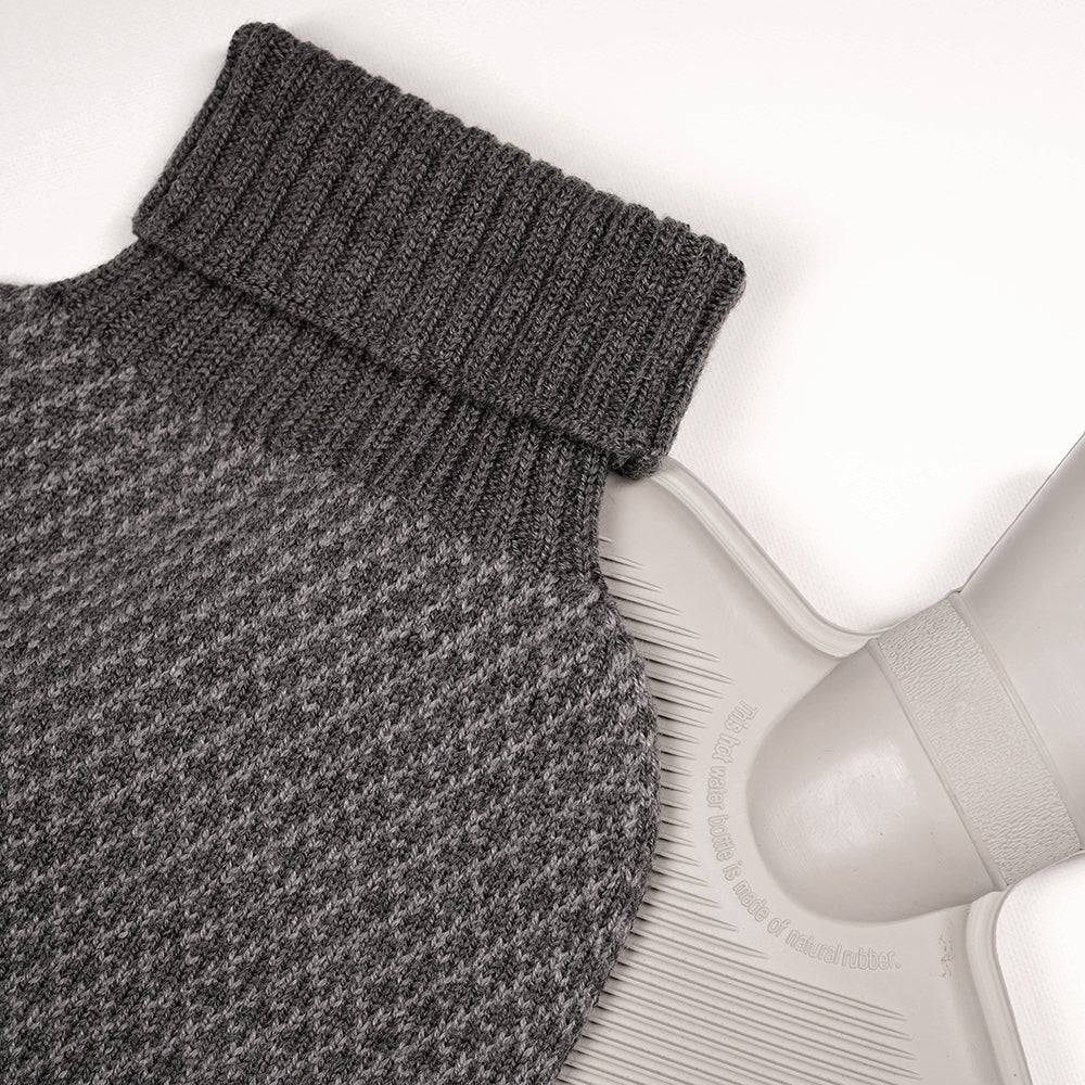 Isobaa | Merino Jacquard Hot Water Bottle Cover (Charcoal/Smoke) | Say goodbye to ordinary hot water bottles! You'll love the luxurious feel of our Merino wool cover – and your skin will thank you! Wrap yourself in cosy warmth, enjoy natural breathability, and discover the ultimate hot water bottle indulgence.