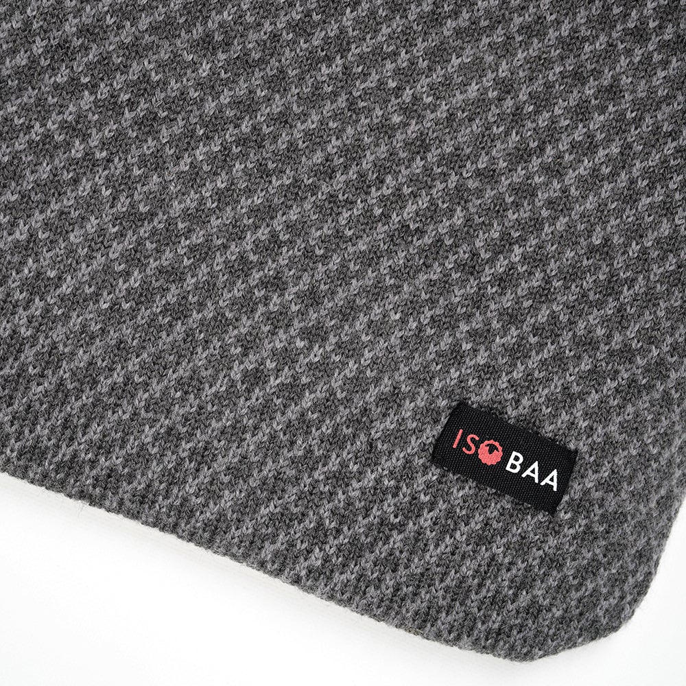 Isobaa | Merino Jacquard Hot Water Bottle Cover (Charcoal/Smoke) | Say goodbye to ordinary hot water bottles! You'll love the luxurious feel of our Merino wool cover – and your skin will thank you! Wrap yourself in cosy warmth, enjoy natural breathability, and discover the ultimate hot water bottle indulgence.