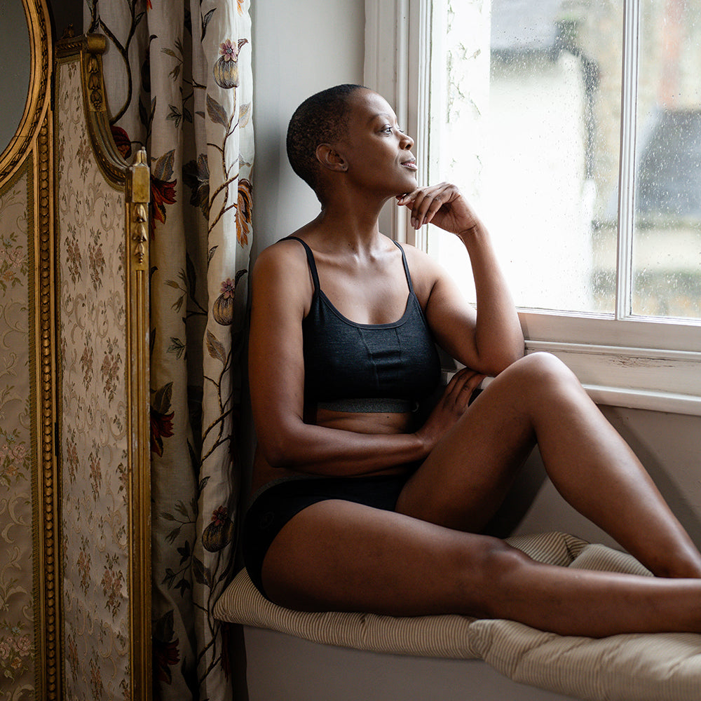 Isobaa | Womens Merino Blend 160 Crop Top (Black Melange) | Discover the ultimate base layer with Isobaa's Merino blend crop top. | Model: Yolisa