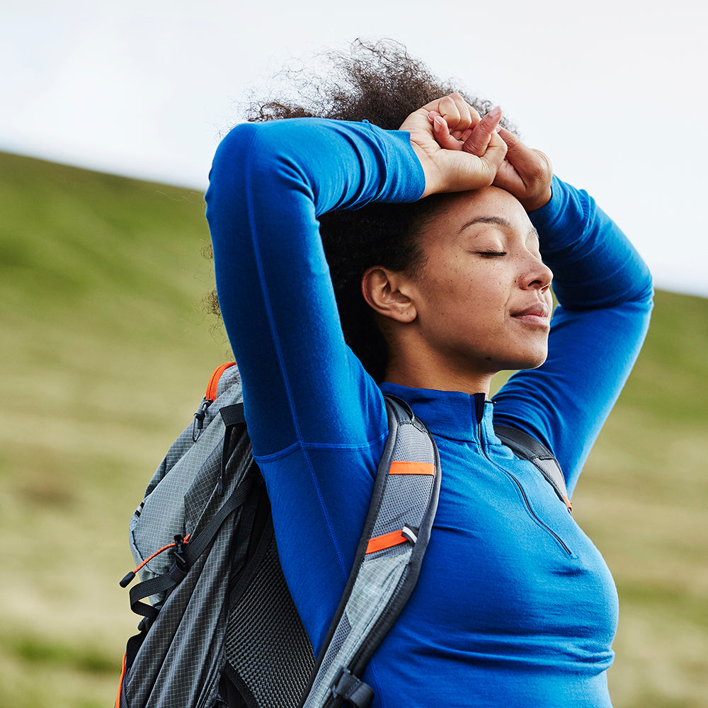Isobaa | Womens Merino 200 Long Sleeve Zip Neck (Blue) | Experience the best of 200gm Merino wool with this ultimate half-zip top – your go-to for challenging hikes, chilly bike commutes, post-workout layering, and unpredictable weather. | Model: Savanah