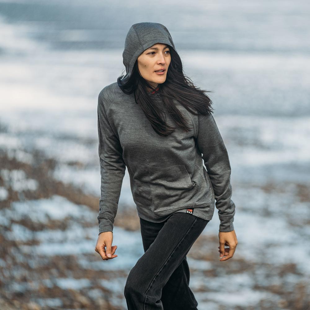Isobaa | Womens Merino 260 Lounge Hoodie (Charcoal/Orange) | Experience the best in comfort and performance with our midweight 260gm Merino wool pullover hoodie. | Model: Jessica