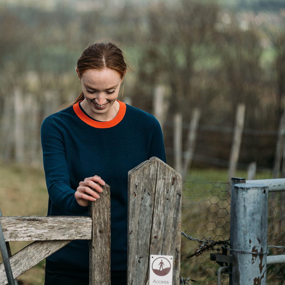 Isobaa | Womens Merino Honeycomb Sweater (Petrol/Orange) | The perfect blend of function and elegance in our extrafine 12-gauge Merino wool crew neck sweater. | Model: Sophie