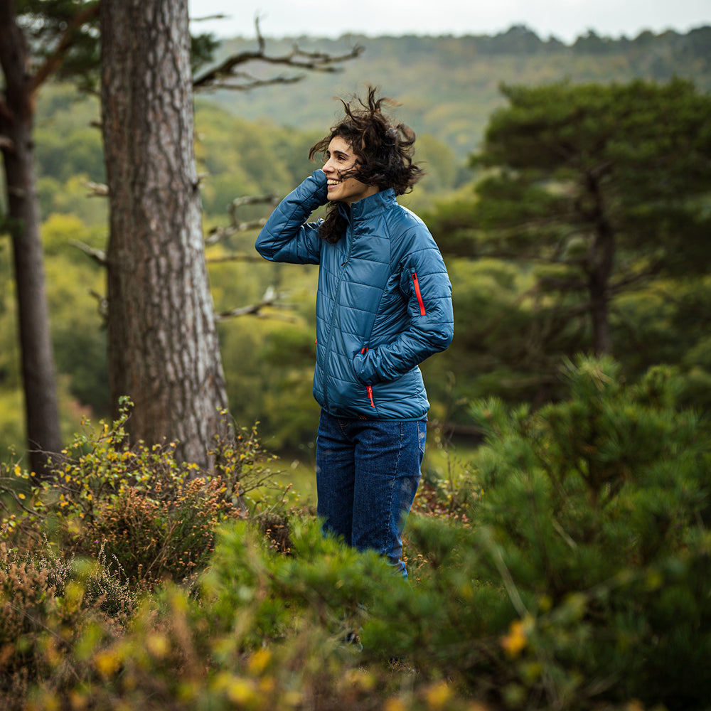 Isobaa | Womens Packable Insulated Jacket (Petrol/Orange) | Exceptional warmth, packable convenience, and sustainable design with our lightweight Merino wool jacket. | Model: Clémentine