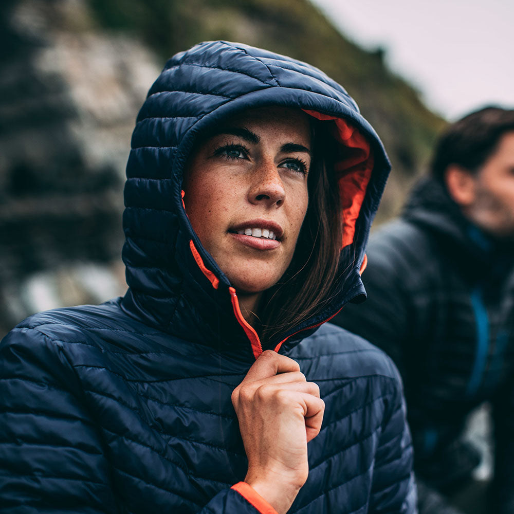 Isobaa | Womens Merino Wool Insulated Jacket (Navy/Orange) | Innovative and sustainable design with our Merino jacket. | Model: Jess