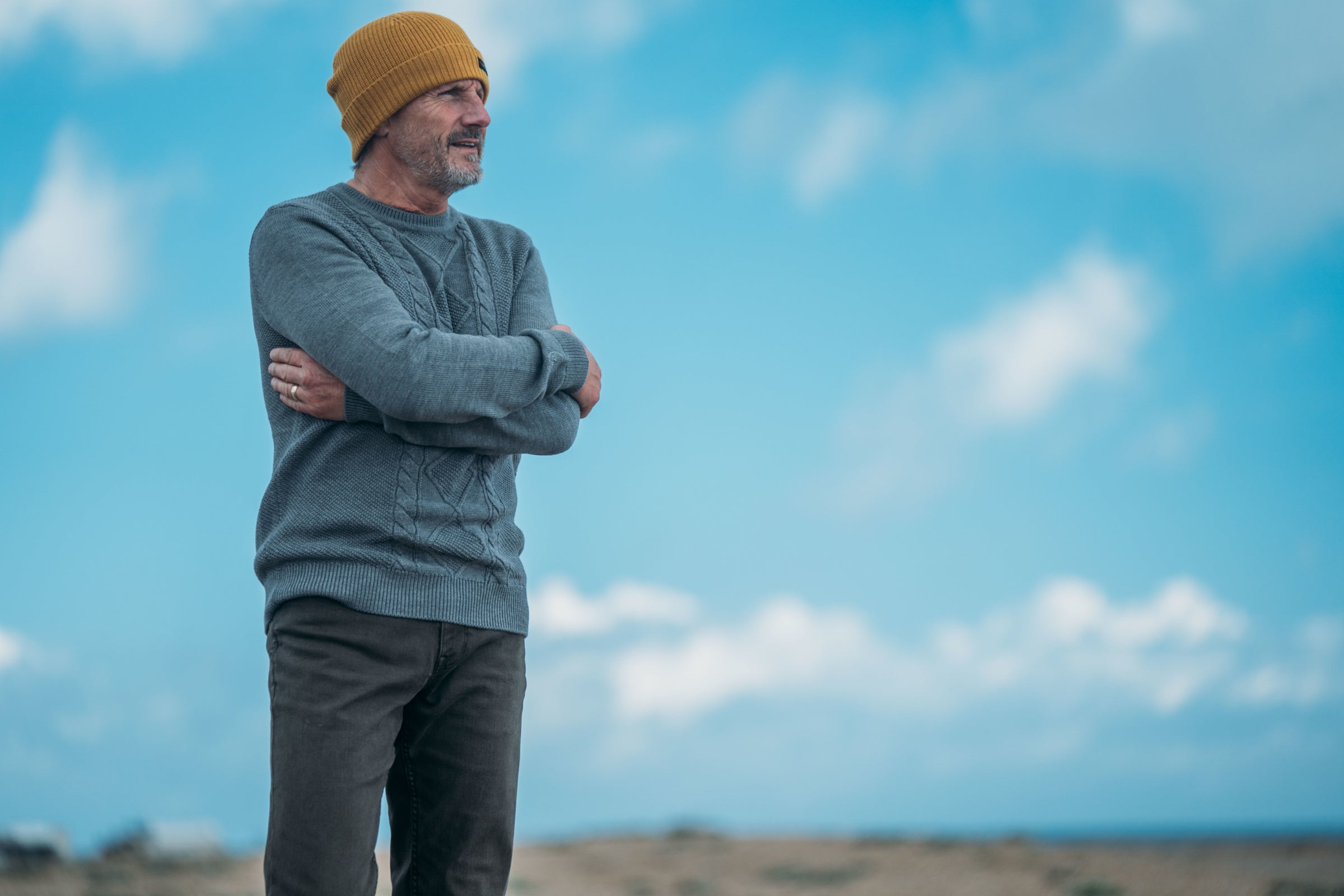 A man in an Isobaa Merino sweater and beanie