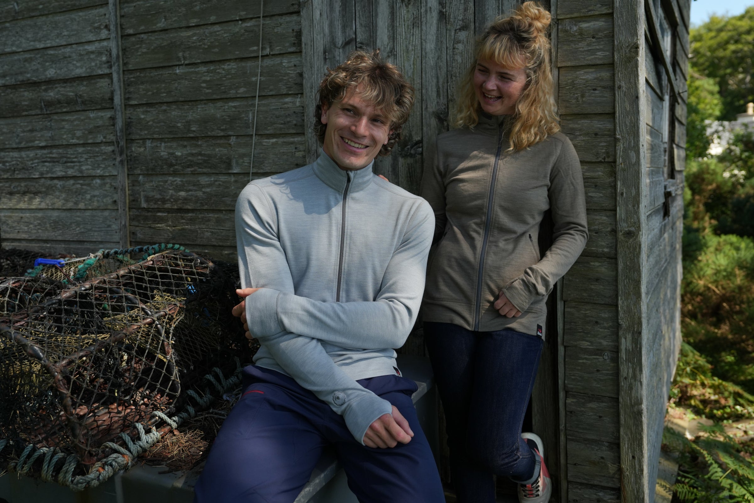 Two people wearing Isobaa merino zip tops outdoors