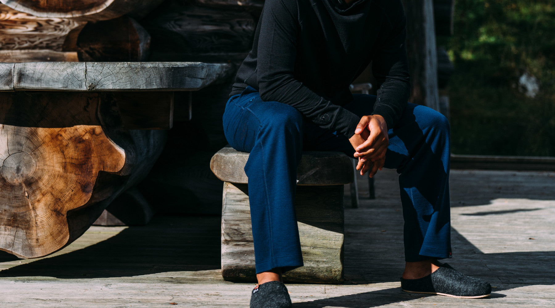 Isobaa Merino 260 Lounge Joggers and 180 Long Sleeve Crew Top on a sunny day outside the log cabin