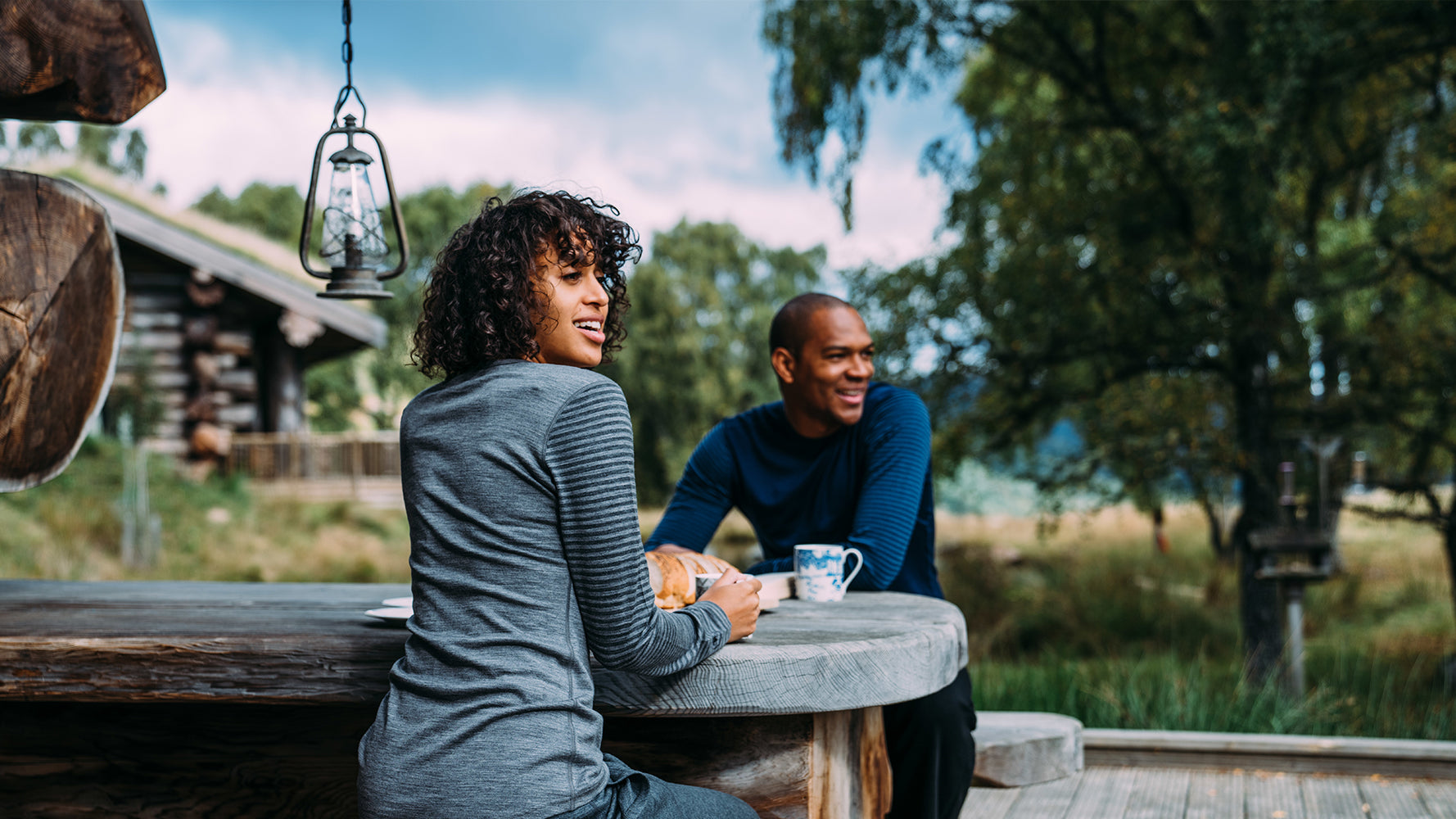 Isobaa Merino 180 Long Sleeve Crew and 260 Lounge Joggers worn on a warm Summer morning while enjoying tea outside the log cabin