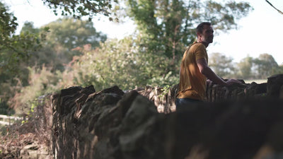 Isobaa | Mens Merino 150 Emblem Tee (Mustard/Navy) | Conquer trails and city streets in comfort with Isobaa's superfine Merino T-Shirt. | class: 90% 50% | Model: Ben