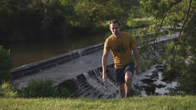 Isobaa | Mens Merino 150 Mountains Tee (Mustard/Navy) | Gear up for adventure with our superfine Merino Tee. | align: 85% 50% | Model: Ben