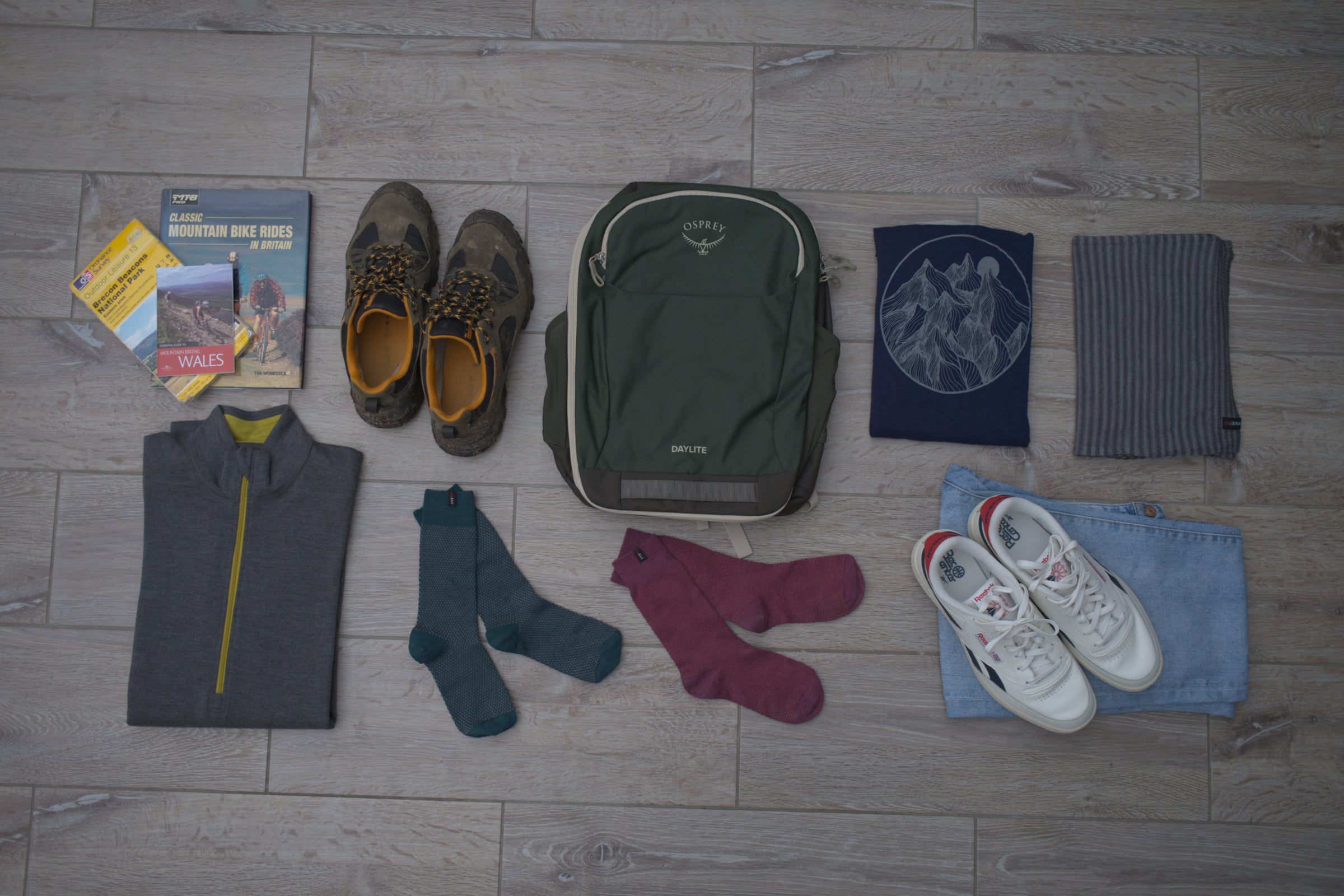 Isobaa Merino items included in an array of packing essentials laid out on the floor