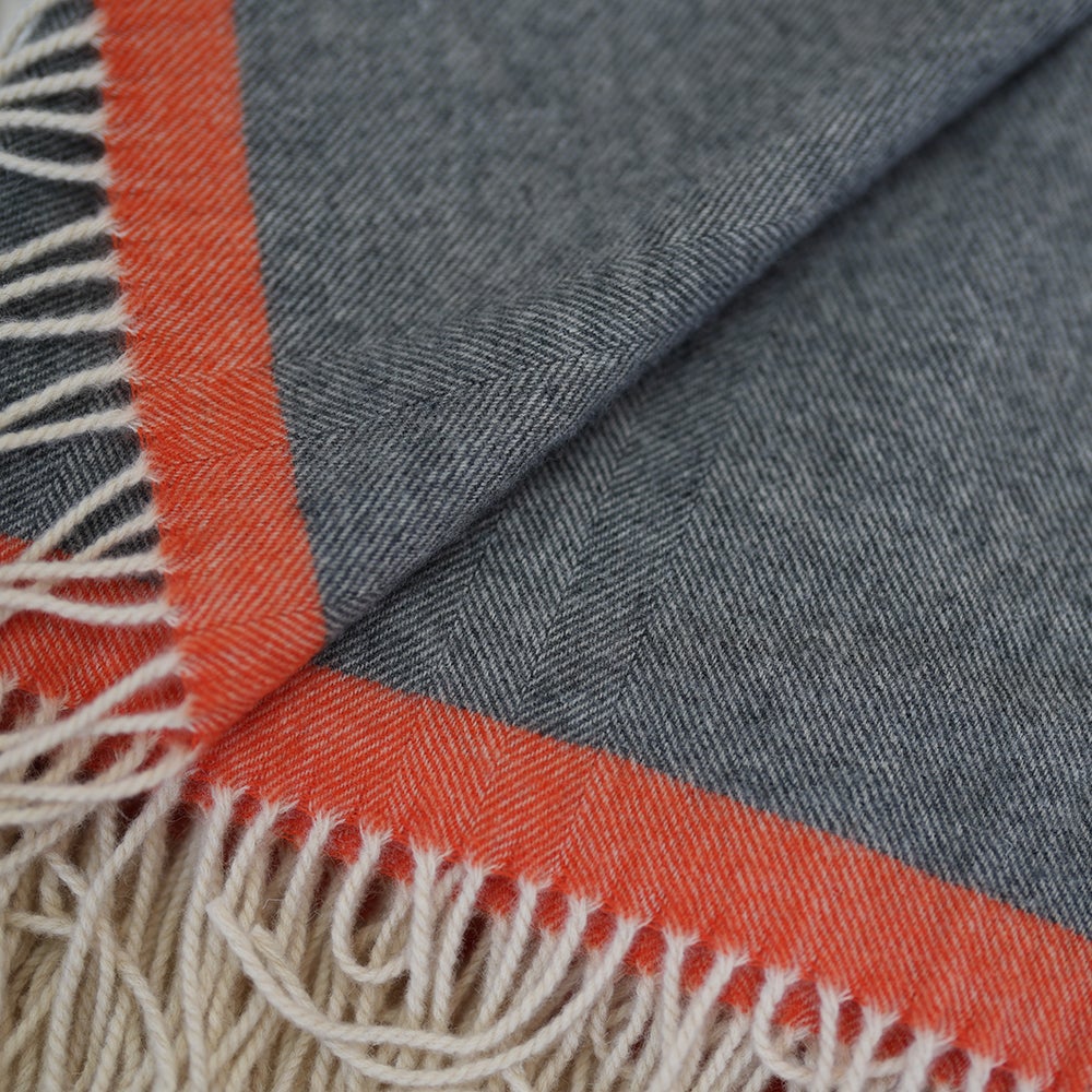 Isobaa | Merino Herringbone Throw (Charcoal/Orange Stripe) | Wrap yourself in pure comfort with Isobaa's super-soft Merino throw.